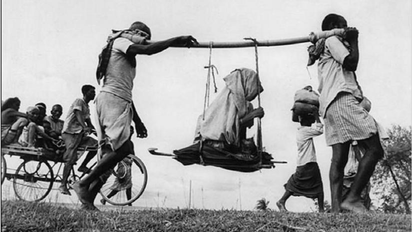 Two Muslim men (in a rural refugee train headed towards Pakistan) carrying an old woman in a makeshift doli or palanquin. 1947. WIKIMEDIA COMMONS