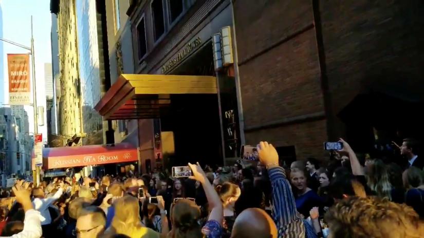People evacuated from a Carnegie Hall concert during a blackout due to widespread power outages in the Manhattan borough of New York City, U.S, listen to the choir singing on the street in this still frame obtained via social media video July 13, 2019.