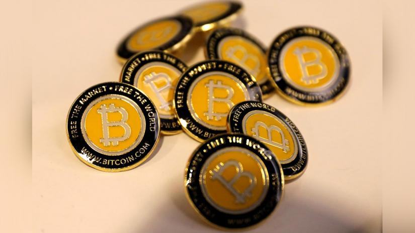Bitcoin.com buttons are seen displayed on the floor of the Consensus 2018 blockchain technology conference in New York City, New York, US, May 16, 2018. REUTERS/File Photo