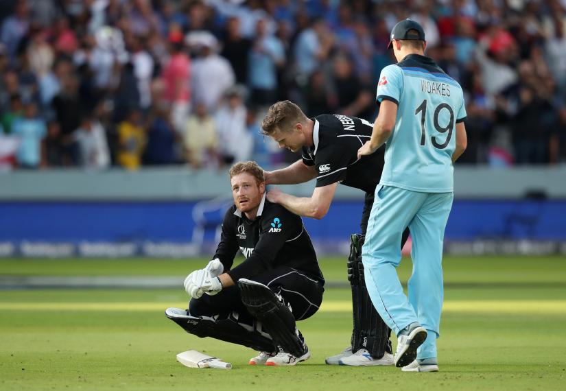 Cricket - ICC Cricket World Cup Final - New Zealand v England - Lord`s, London, Britain - July 14, 2019 New Zealand`s Martin Guptill is consoled by teammate James Neesham after England win the World Cup following a super over Action Images via Reuters