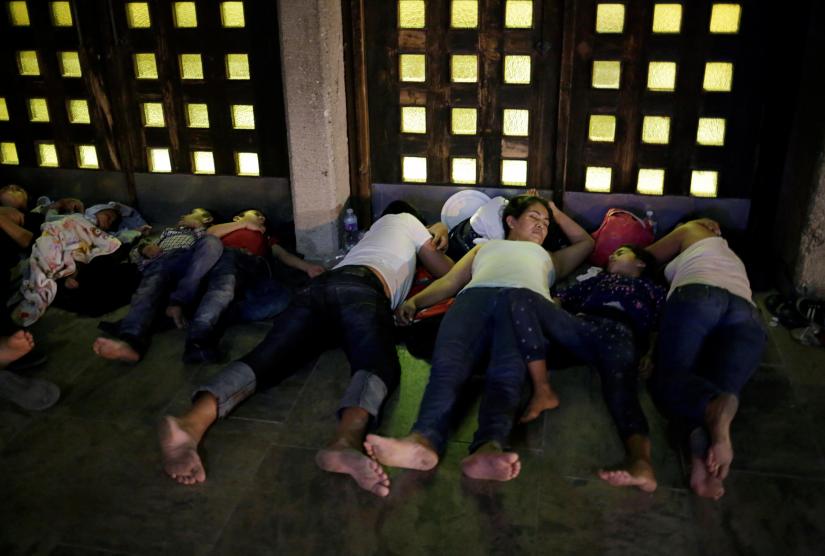 Central American migrants, who returned to Mexico from the United States to await their court hearing for asylum seekers, as part of the legal proceedings under a new policy established by the U.S. government, sleep outside the Our Lady of Guadalupe Cathedral in Ciudad Juarez, Mexico, July 14, 2019. Picture taken July 14, 2019. REUTERS/File Photo