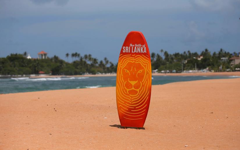 A surfboard is seen in the middle of an empty beach, near hotels at Unawatuna beach in Galle, Sri Lanka July 4, 2019. Picture taken July 4, 2019. REUTERS