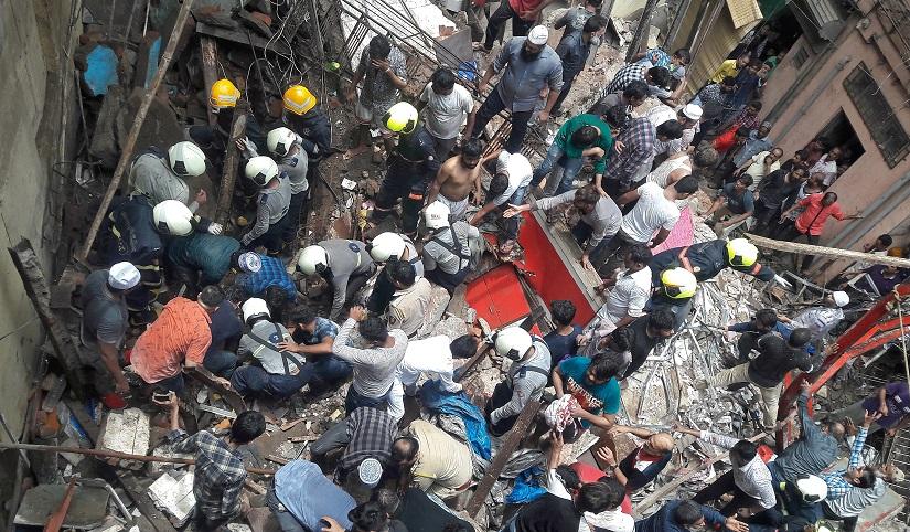 Rescue workers and residents search for survivors at the site of a collapsed building in Mumbai, India, July 16, 2019. REUTERS