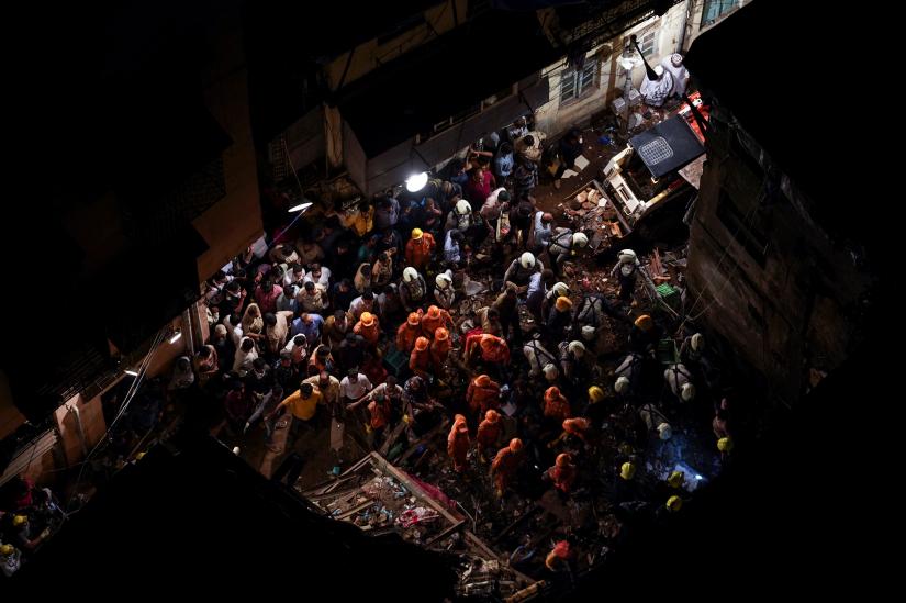 Rescue workers search for survivors at the site of a collapsed building in Mumbai, India, July 16, 2019. REUTERS