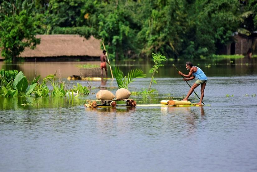 A man uses a makeshift raft to move his paddy to a safer place in a flooded area in Morigaon district in the northeastern state of Assam, India, July 16, 2019. REUTERS