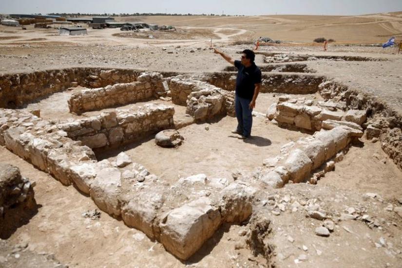 An archaeologist gestures as he stands inside the remains of a mosque discovered by the Israel Antiquities Authority and which they say is one of the world`s oldest mosques, in the outskirts of the Bedouin town of Rahat in southern Israel Jul 18, 2019. REUTERS