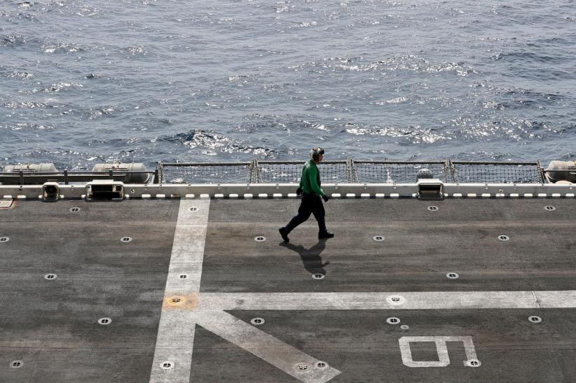 A US sailor walks on the flight deck of USS Boxer (LHD-4) in the Arabian Sea off Oman Jul 16, 2019. REUTERS/File Photo