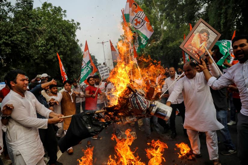 Supporters of India`s main opposition Congress Party burn an effigy during a protest against stopping of their leader Priyanka Gandhi Vadra from visiting a village where tribal people were gunned down this week over a land dispute, in New Delhi, India, July 19, 2019. REUTERS