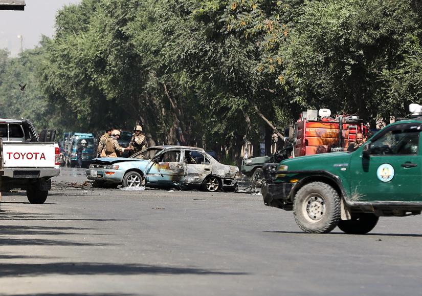 Members of Afghan security forces inspect the site of a blast near Kabul University in Kabul, Afghanistan July 19, 2019. REUTERS