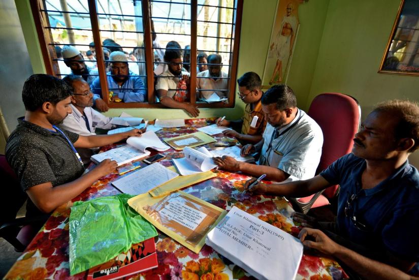 People wait to check their names on the draft list at the National Register of Citizens (NRC) centre at a village in Nagaon district, Assam state, India, Jul 30, 2018. REUTERS/File Photo