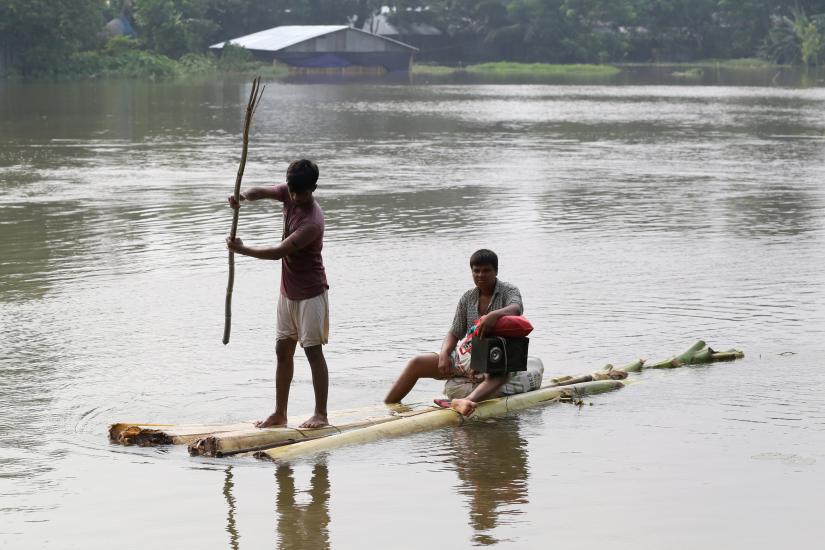 People use a makeshift raft to move on a flooded area in Gaibandha, Bangladesh July 18, 2019. REUTERS