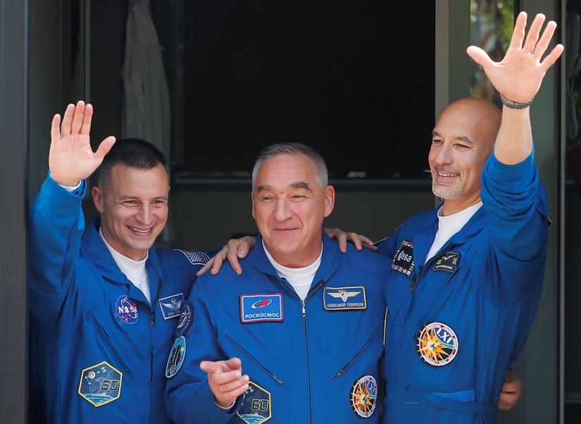 International Space Station (ISS) crew formed of NASA astronaut Andrew Morgan, Alexander Skvortsov of the Russian space agency Roscosmos and Luca Parmitano of European Space Agency (ESA) leave for a pre-launch preparation at the Baikonur Cosmodrome, Kazakhstan, July 20, 2019. REUTERS