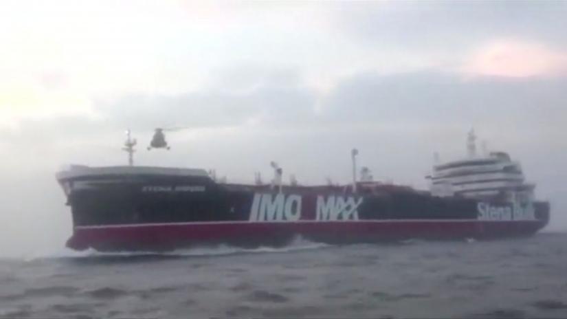 A helicopter hovers over British-flagged tanker Stena Impero near the strait of Hormuz July 19, 2019, in this still image taken from video.