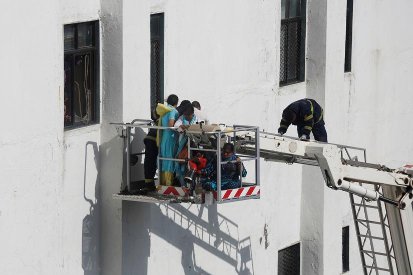 Firemen rescue people from Mahanagar Telephone Nigam Limited (MTNL) building after a fire broke out, in Mumbai, India, July 22, 2019. REUTERS