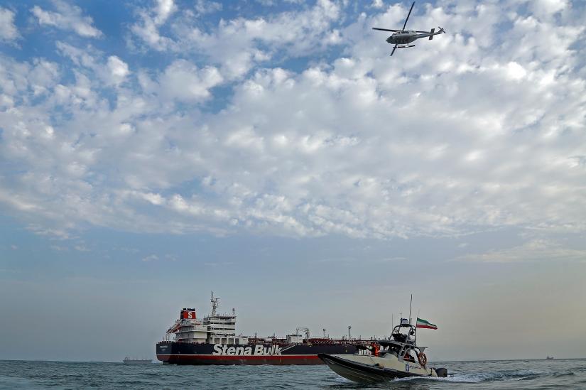 A boat of the Iranian Revolutionary Guard sails next to Stena Impero, a British-flagged vessel owned by Stena Bulk, at Bandar Abbas port, July 21, 2019. Mizan News Agency/WANA Handout via REUTERS