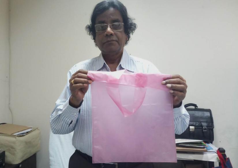 Scientist Mubarak Ahmad Khan holds one of the jute-based `Sonali` bags he invented as a replacement for plastic bags, in his office in Dhaka, Bangladesh, March 13, 2019. Thomson Reuters Foundation