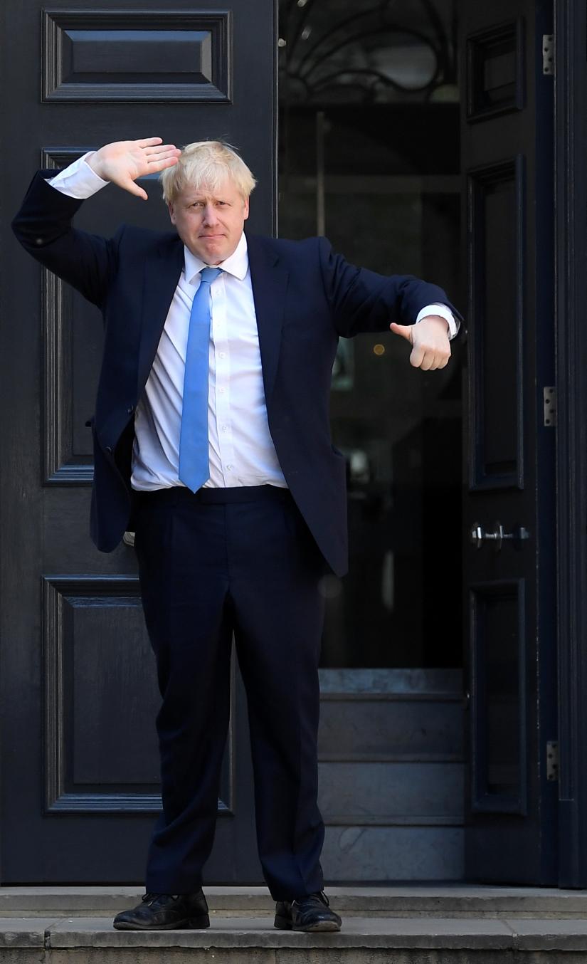 Boris Johnson gestures as he arrives at the Conservative Party headquarters, after being announced as Britain`s next Prime Minister, in London, Britain July 23, 2019. REUTERS
