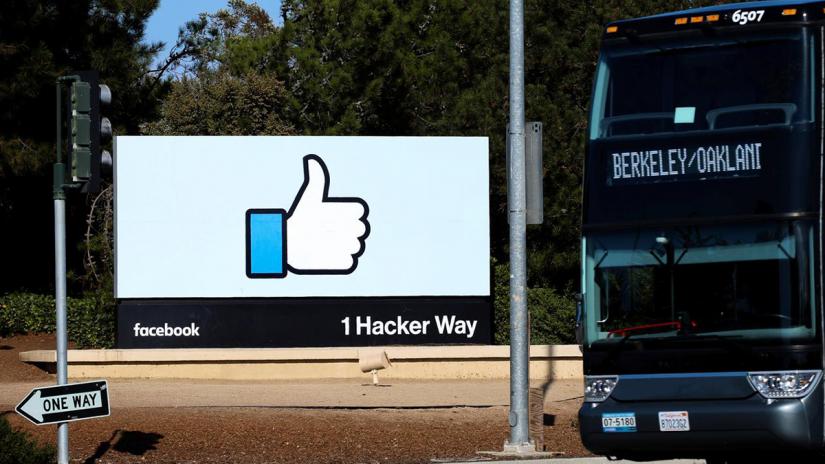 FILE PHOTO: An employee bus is seen next to the entrance sign to Facebook headquarters in Menlo Park, California, on Wednesday, Oct 10, 2018. REUTERS