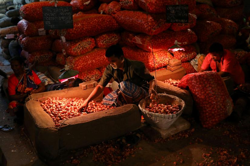 People work at an onion wholesale market in the Kawran Bazar in Dhaka, Bangladesh, July 24, 2019. REUTERS