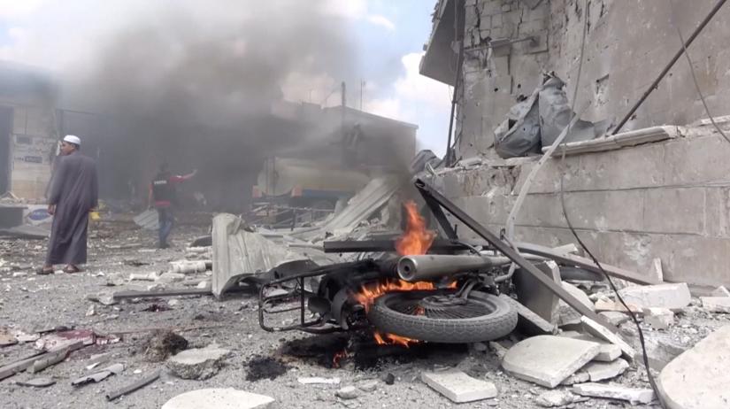 FILE PHOTO: A White Helmets member uses a saw on rubble after an airstrike in this screen grab taken from a social media video said to be taken in Idlib, Syria on July 16, 2019. Picture taken July 16, 2019. White Helmets/social media via REUTERS