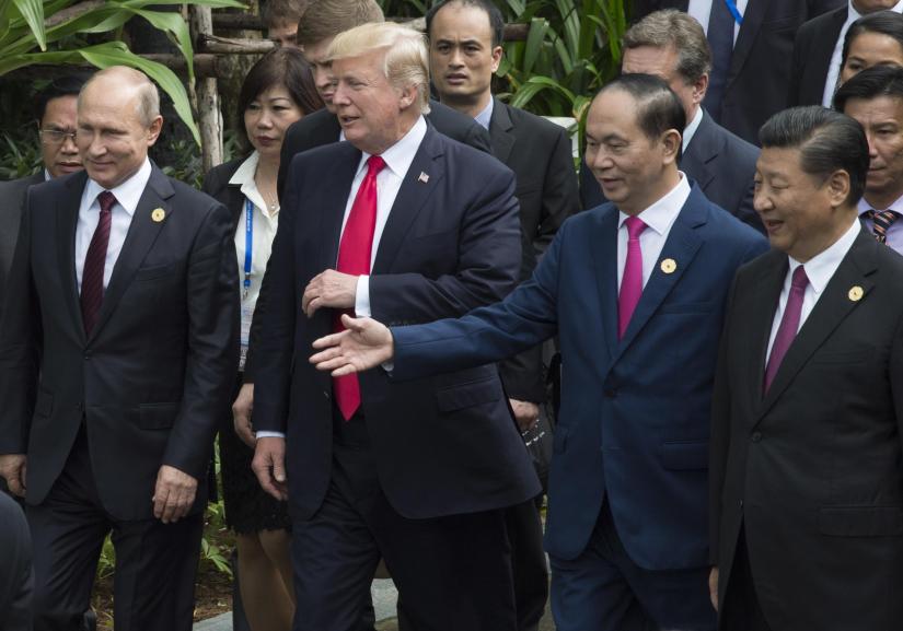 Left to right; Russian President Vladimir Putin, U.S. President Donald Trump, late Vietnamese President Tran Dai Quang and Chinese President Xi Jinping walk to the group photo at the APEC Summit in Danang, Vietnam, Saturday, Nov. 11, 2017. The Canadian Press/File Photo