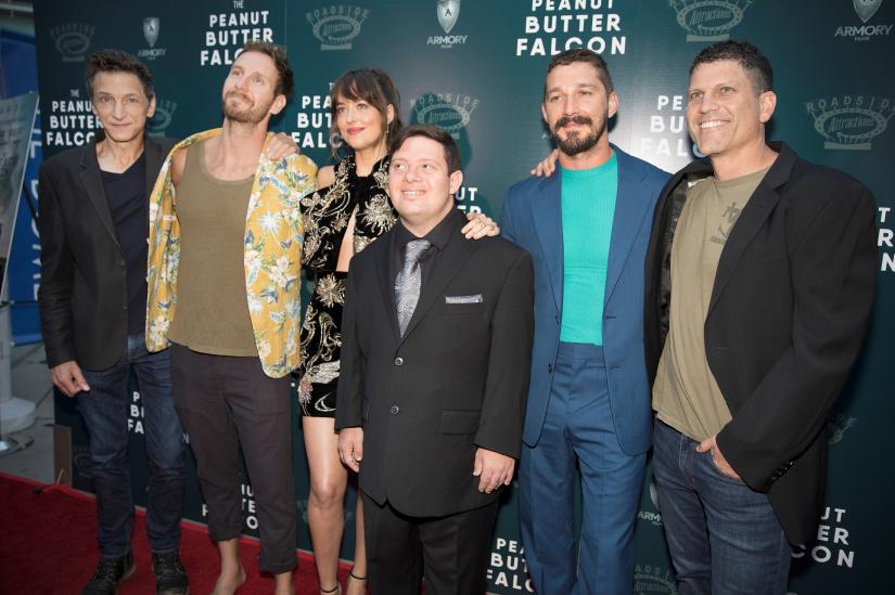 John Hawkes, writer and director Tyler Nilson, Dakota Johnson, Zack Gottsagen, Shia LeBeouf and writer and director Michael Schwartz arrive for the screening of the film The Peanut Butter Falcon in Los Angeles, California, U.S., August 1, 2019. REUTERS