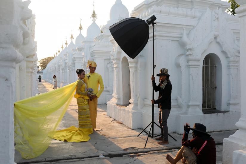 A couple poses for a wedding photo shoot at Kuthodaw Pagoda in Mandalay, Myanmar, March 29, 2019. REUTERS