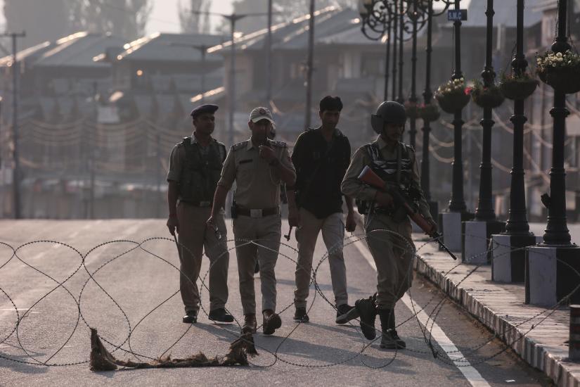 Indian security personnel patrol on deserted road during restrictions in Srinagar, August 5, 2019. REUTERS