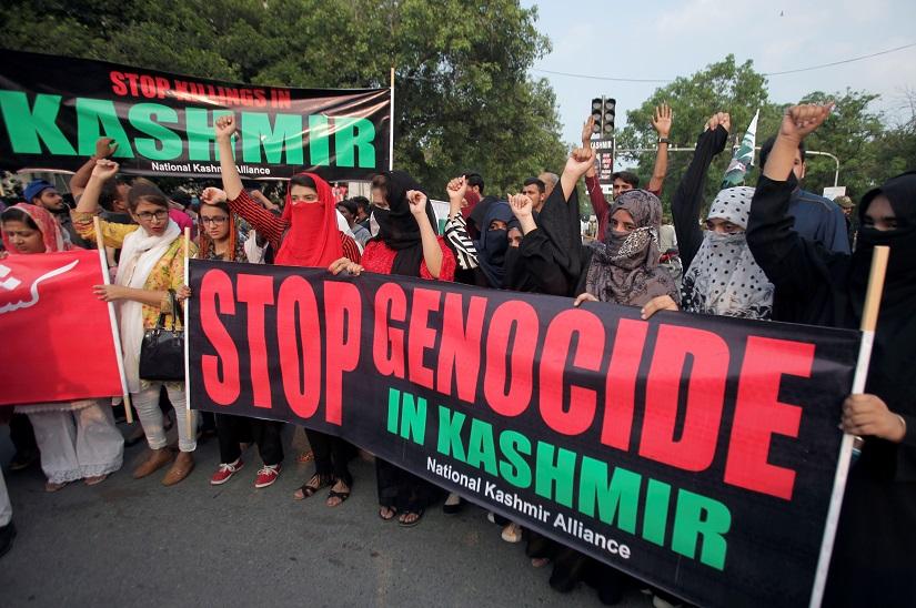 People hold banners and chant slogans during a rally in solidarity with the people of Kashmir, in Lahore, Pakistan August 5, 2019. REUTERS