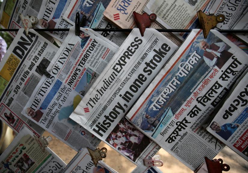Newspapers, with headlines about Prime Minister Narendra Modi`s decision to revoke special status for the disputed Kashmir region, are displayed for sale at a pavement in Ahmedabad, India, August 6, 2019. REUTERS