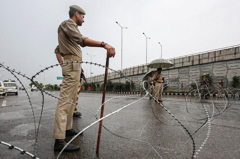 Indian security personnel stand guard along a deserted street during restrictions in Jammu, August 7, 2019. REUTERS