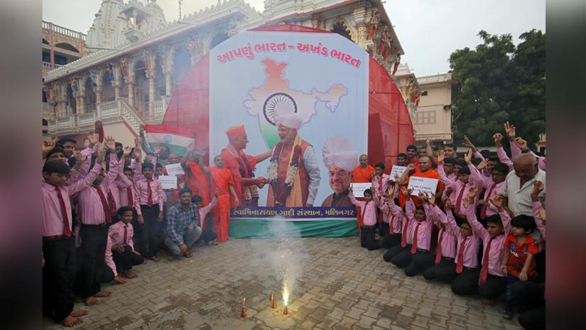 Fireworks explode as Hindu saints and school children celebrate scrapping of special constitutional status for Kashmir, in Ahmedabad, India, August 6, 2019. REUTERS