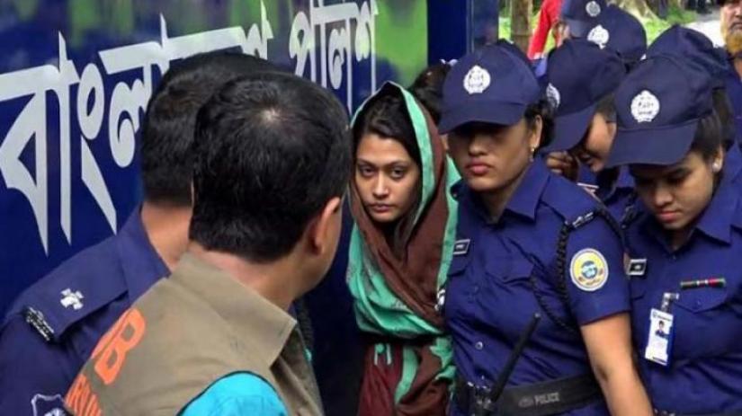 Slain Rifat Sharif`s wife Ayesha Siddiqua Minni is seen being escorted by police in this photo taken in Jul 2019.