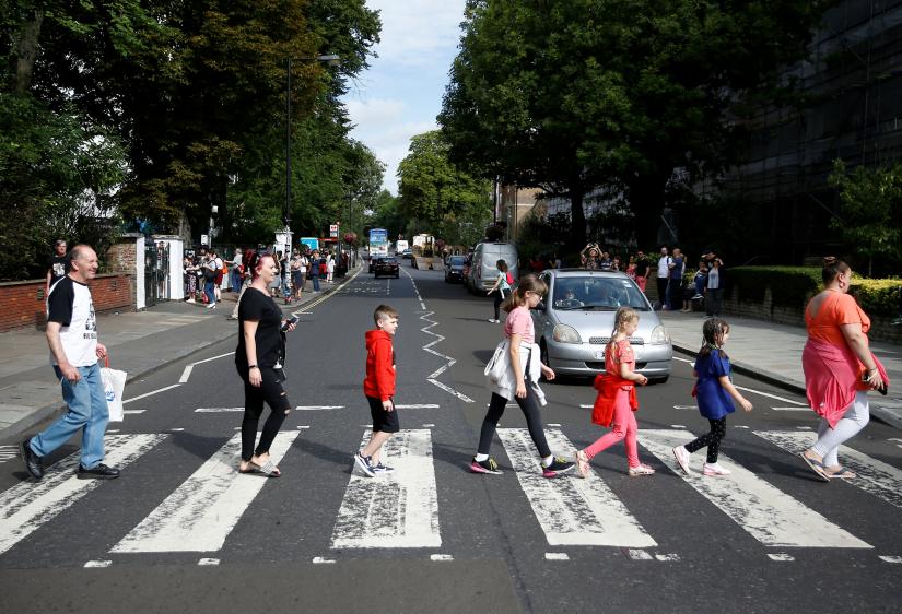 Fans recreate the iconic Beatles photo on Abbey Road in London, Britain August 8, 2019. REUTERS