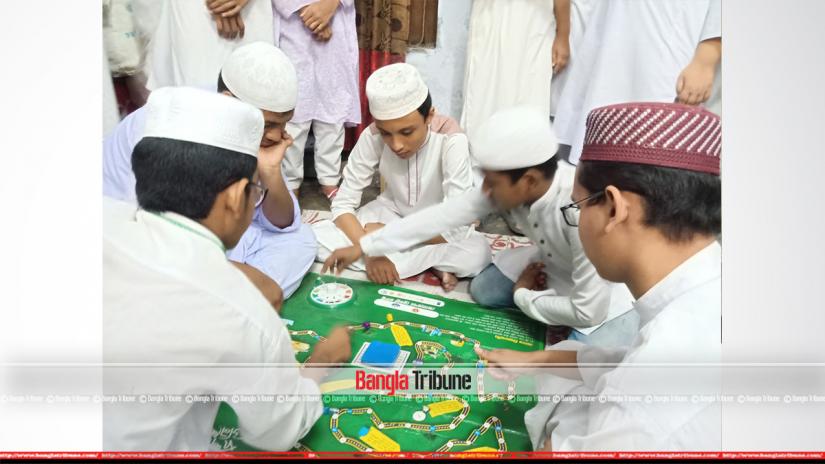Students at Dhaka`s Tamirul Millat Kamil Madrasah are seen playing a game aimed at taking lessons about reproduction and sexual health.