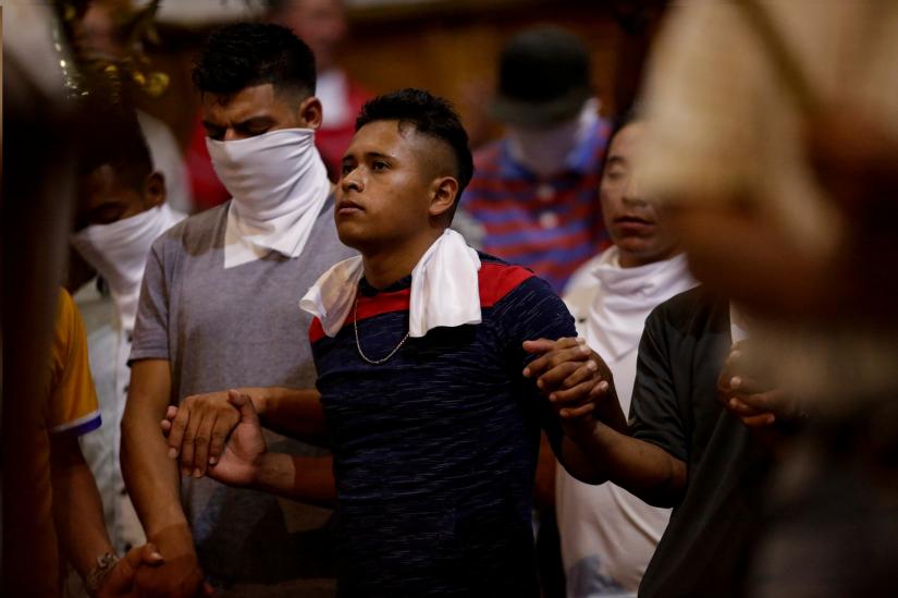 Central American migrants take part in a mass in honour of Honduran migrant Marco Tulio, who according to the Attorney General`s Office of Coahuila was shot dead by a member of a state police unit near a train station, at Santiago cathedral in Saltillo, Mexico August 3, 2019.