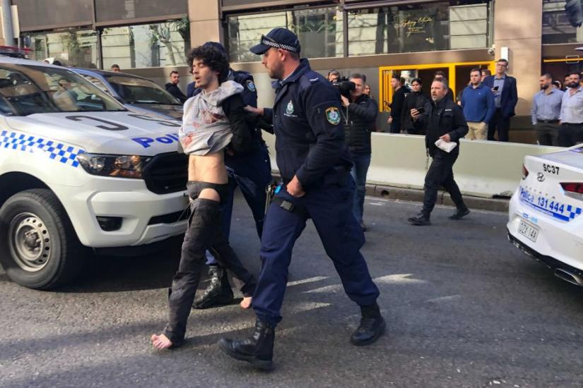 A man is arrested after reportedly stabbing people in Sydney. A group of people had held him down before he was arrested.