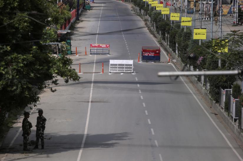 Indian security personal stand guard on a deserted road during restrictions on the Eid-al-Adha after the scrapping of the special constitutional status for Kashmir by the Indian government, in Srinagar, August 12, 2019. REUTERS