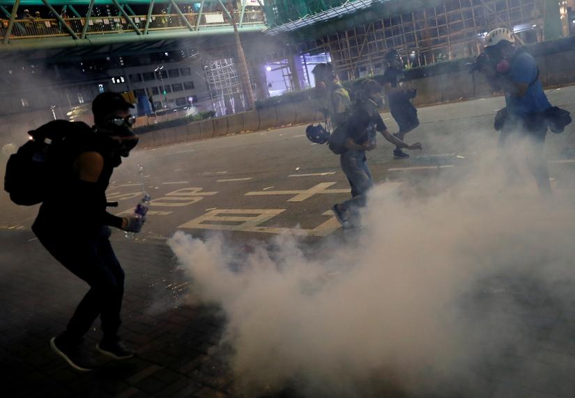 Anti-extradition bill protesters react after the police fired tear gas to disperse the demonstration at Sham Shui Po, in Hong Kong, China August 14, 2019. REUTERS