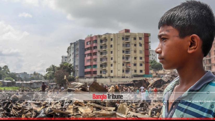 A boy looks on the ashes as a guts hundreds of shanties at a large slum in Dhaka’s Mirpur Section 7 and left thousands homeless on Friday (Aug 16).  SAZZAD HOSSAIN