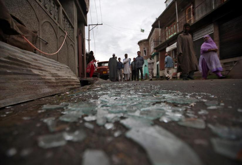 Kashmiris walk past broken window glass after clashes between protesters and the security forces on Friday evening, during restrictions following the scrapping of the special constitutional status for Kashmir by the Indian government, in Srinagar August 17, 2019. REUTERS