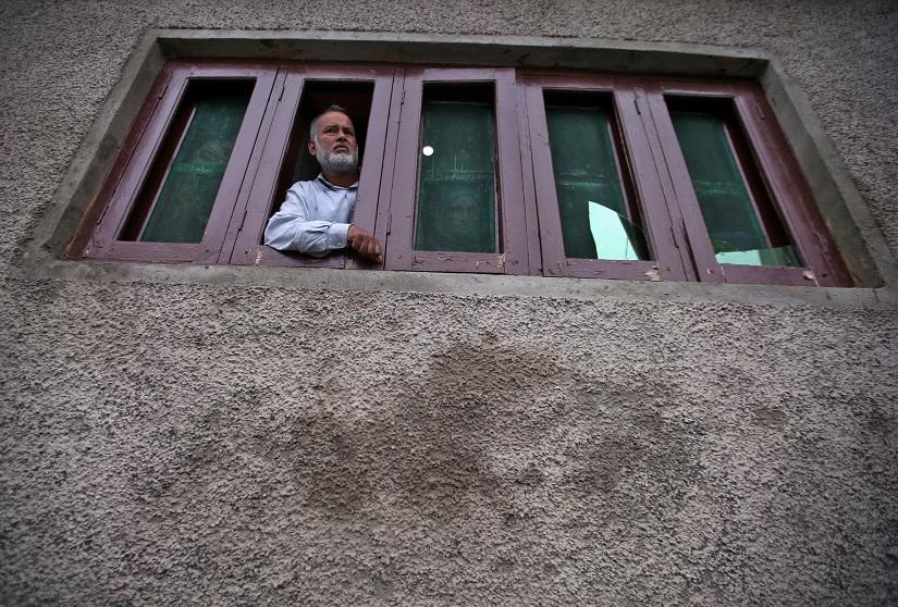 A Kashmiri man looks out from a window of his house which was allegedly damaged by Indian security forces after clashes between protesters and the security forces on Friday evening, during restrictions after the scrapping of the special constitutional status for Kashmir by the Indian government, in Srinagar August 17, 2019. REUTERS