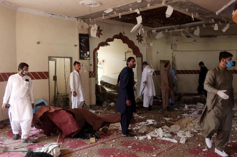 Members of a bomb disposal unit survey the site after a blast at a mosque in Kuchlak, in the outskirts of Quetta, Pakistan August 16, 2019. REUTERS