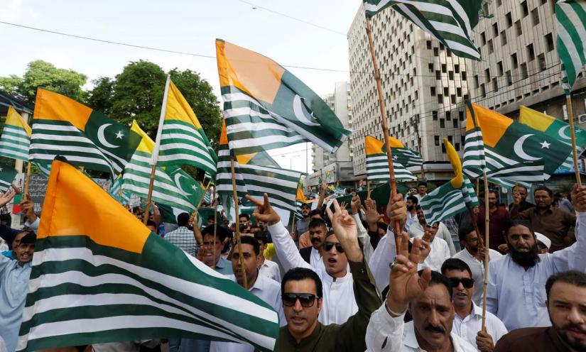 People carry Azad Kashmir`s flags and chant slogans over India`s decision to revoke the special status of Jammu and Kashmir, during a protest in Karachi, Pakistan August 18, 2019. REUTERS