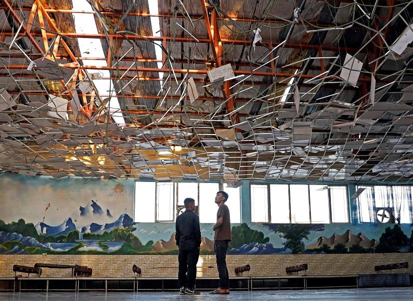 Workers inspect a damaged wedding hall after a blast in Kabul, Afghanistan August 18, 2019. REUTERS