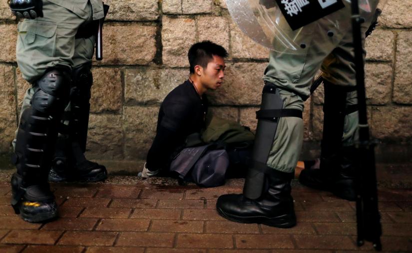 Riot police officers detain an anti-extradition bill protester during a demonstration in Tsim Sha Tsui neighbourhood in Hong Kong, China, August 11, 2019. Picture taken August 11, 2019. REUTERS