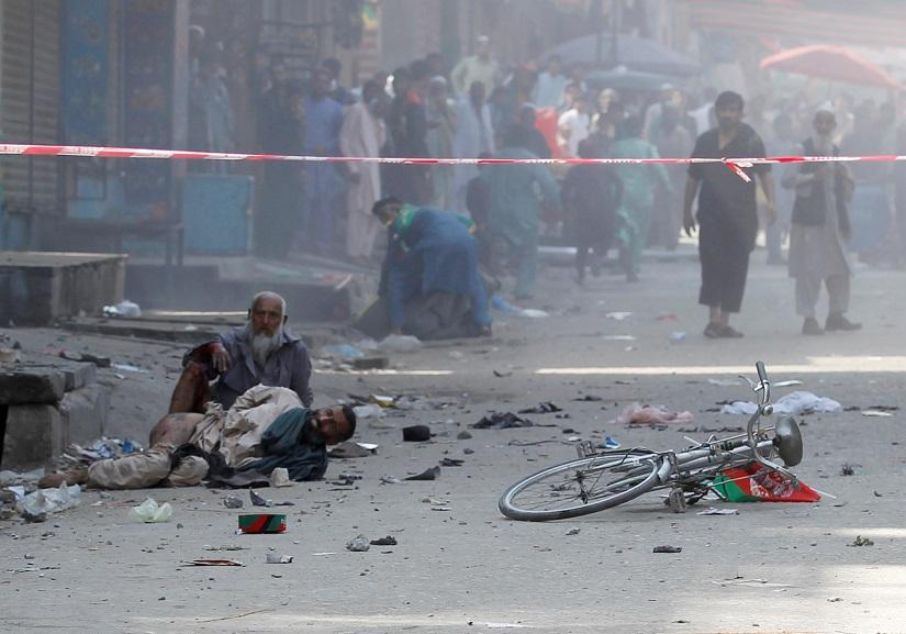 Wounded men lay on the ground as they wait transfer to the hospital, after a blast in Jalalabad, Afghanistan Aug 19, 2019. REUTERS