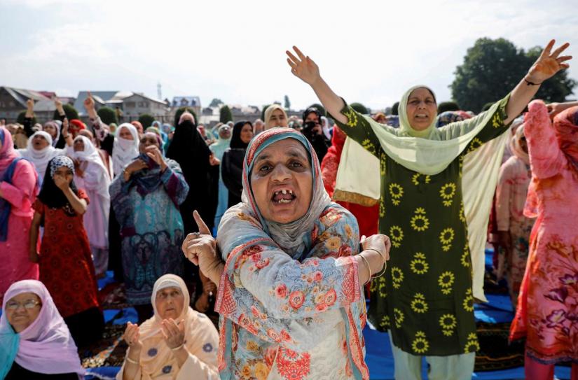 FILE PHOTO: Kashmiri women shout pro-freedom slogans before offering Eid-al-Adha prayers at a mosque during restrictions following the scrapping of the special constitutional status for Kashmir by the Indian government, in Srinagar, Aug 12, 2019. REUTERS