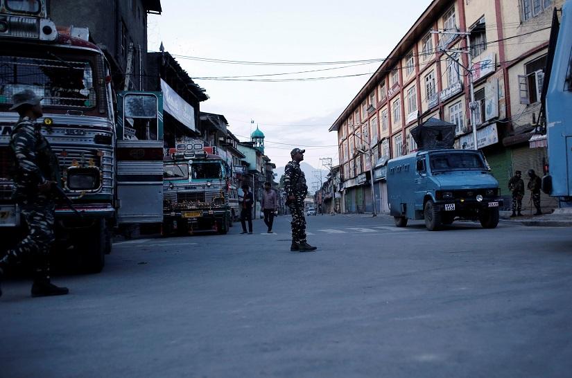 Indian security force personnel stand guard on a deserted road during restrictions after scrapping of the special constitutional status for Kashmir by the Indian government, in Srinagar, August 20, 2019. REUTERS