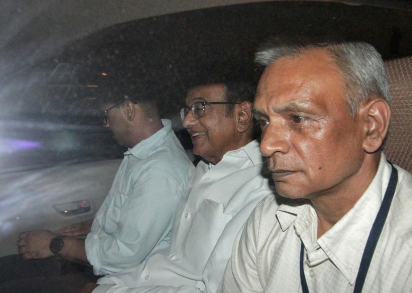 India`s former Finance Minister Palaniappan Chidambaram (C) sits in a vehicle after he was arrested by the Central Bureau of Investigation (CBI) officials in his residence in New Delhi, India, August 21, 2019. REUTERS
